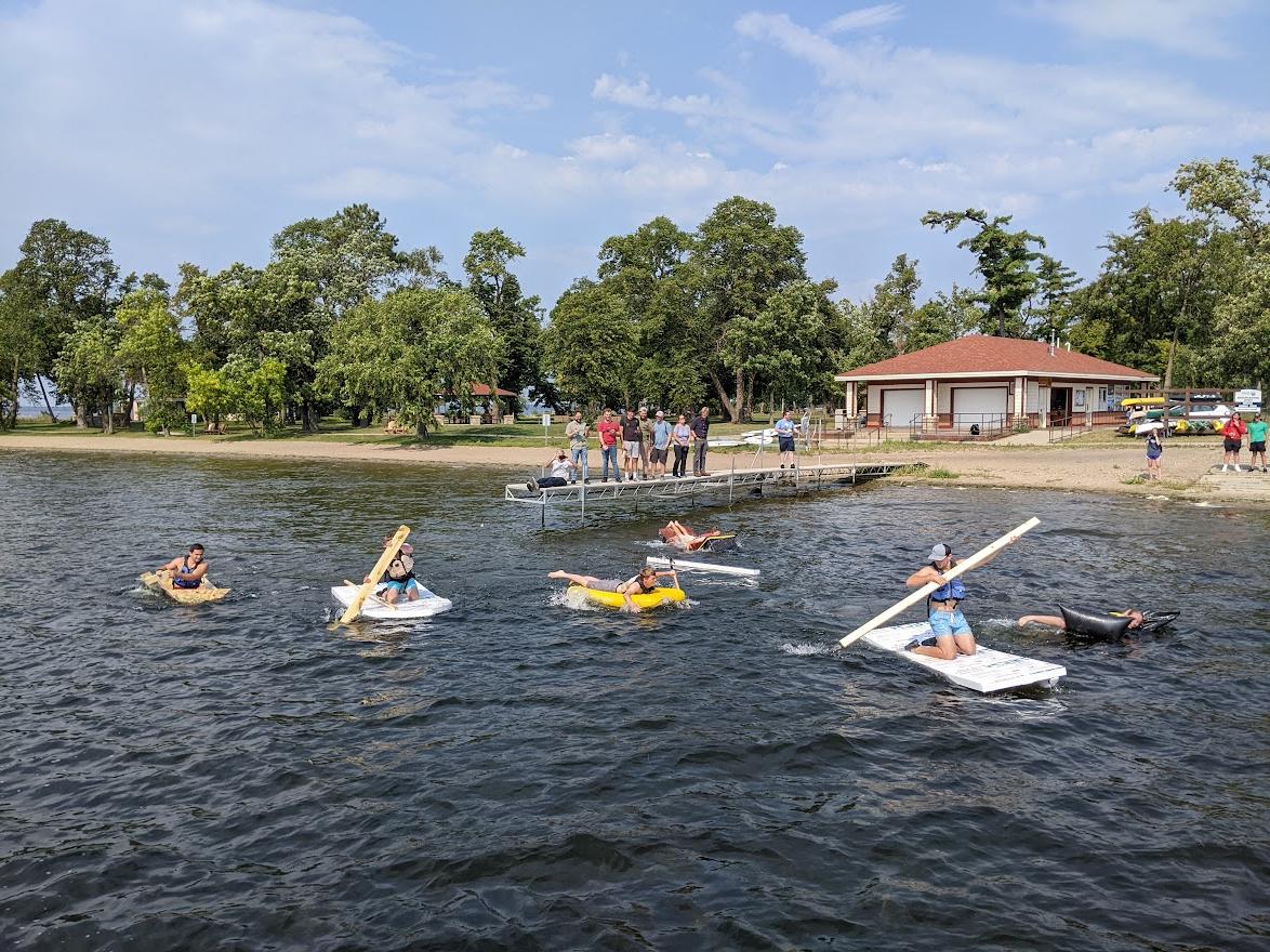 Bemidji State TAD Engineering students in boats they made for class, trying not to sink in Lake Bemidji